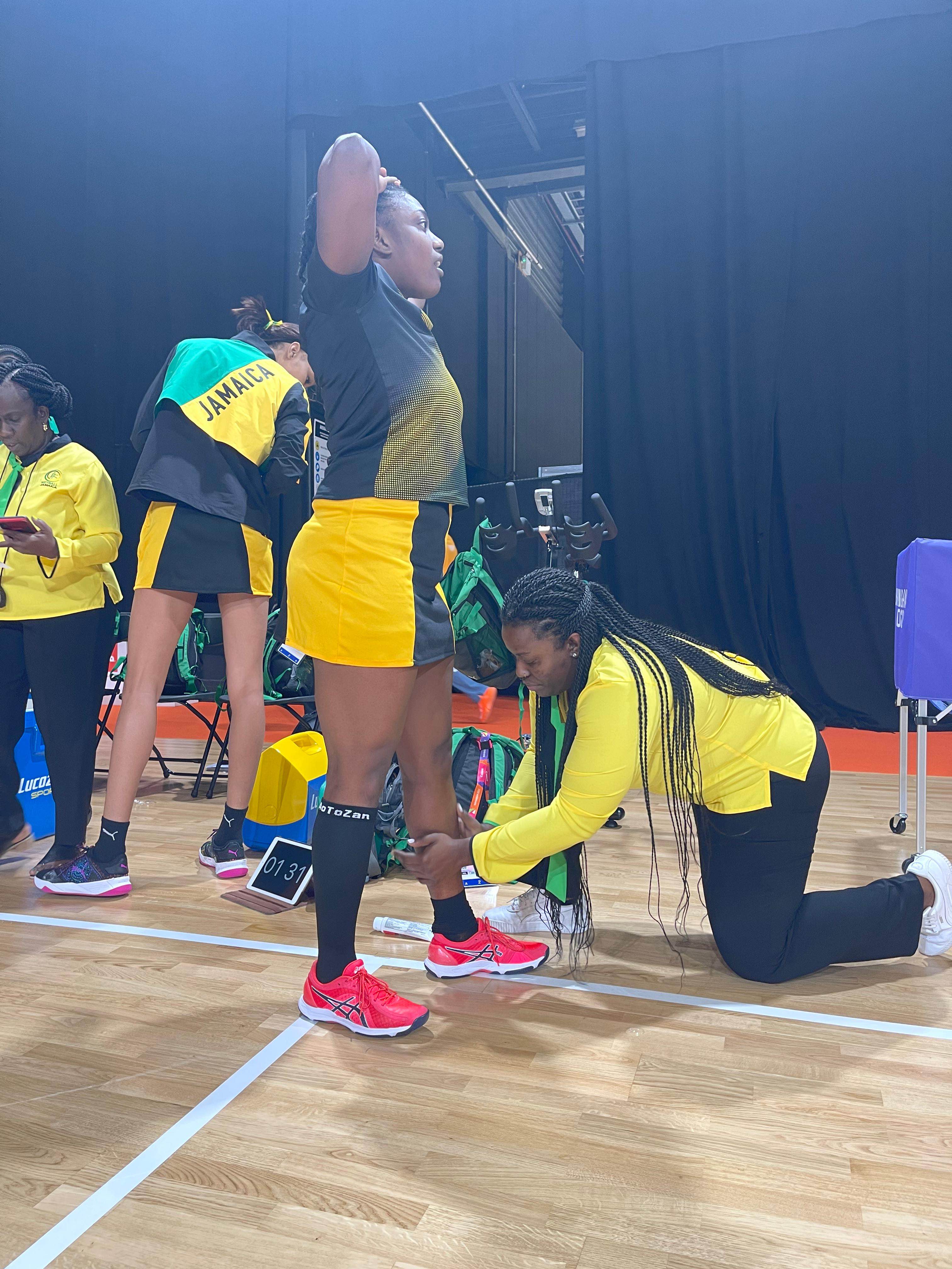 Nicole assisting an athlete courtside